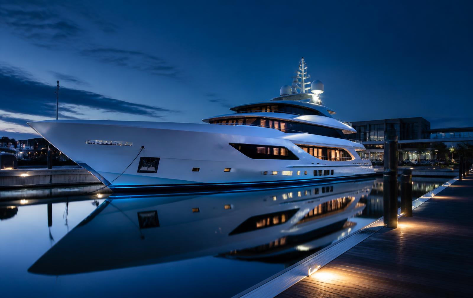 Superyacht moored at a marina at blue hour